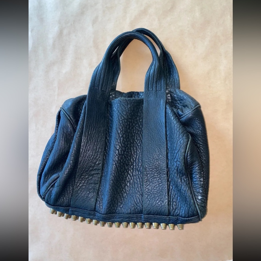 Alexander wang bag 4 studs missing at the bottom.